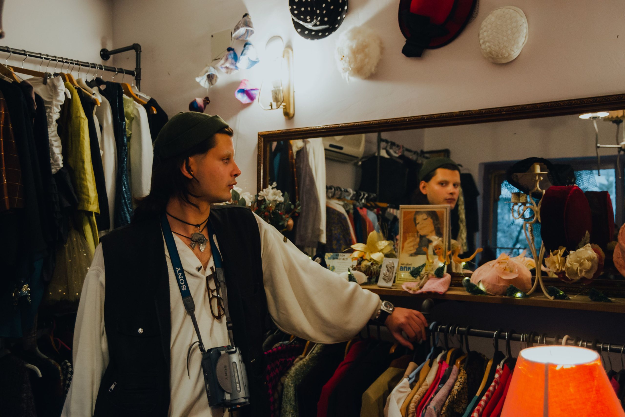 Client essayant vêtements vintage devant miroir